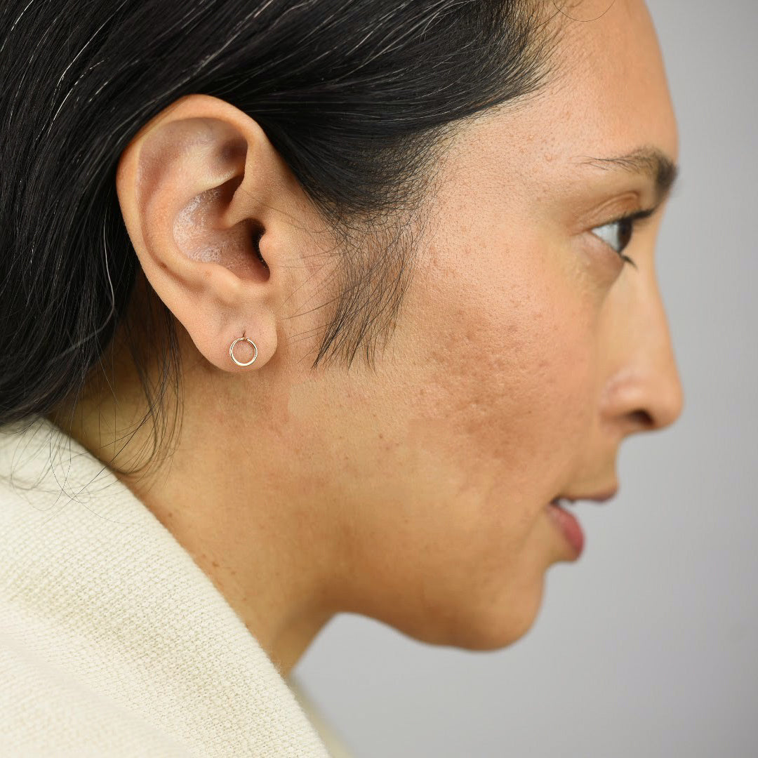 Close up image of a model wearing 14K gold fill Circle Post Earrings from Zurina Ketola