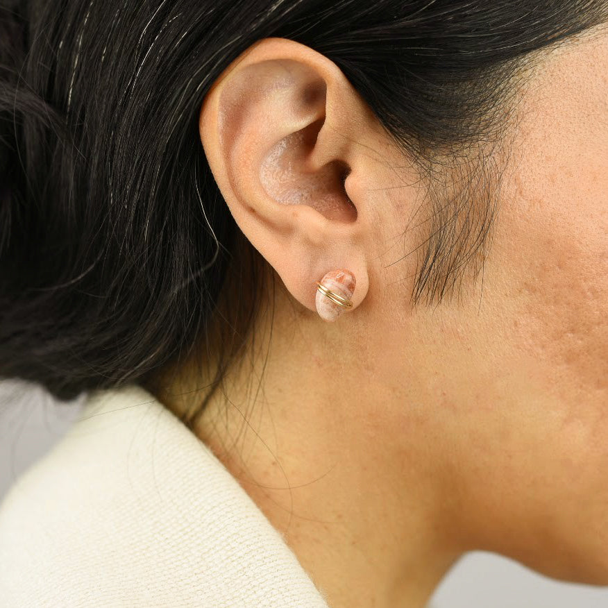 Close up image of a model wearing 14K gold fill Smooth Sunstone Post Earrings from Zurina Ketola