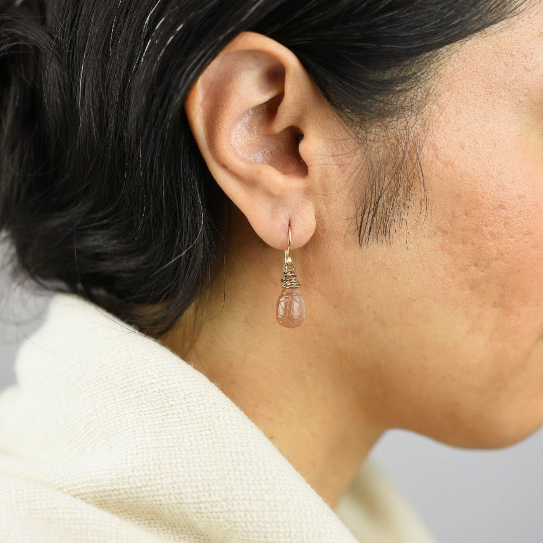 Close up image of a model wearing 14K gold fill Chocolate Moonstone Lotus Earrings from Zurina Ketola