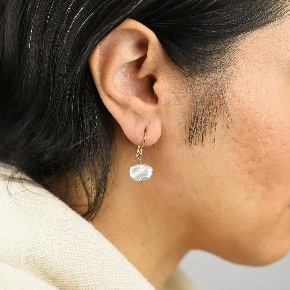 Close up image of a model wearing 14K rose gold fill Organic Gray Pearl Drops from Zurina Ketola