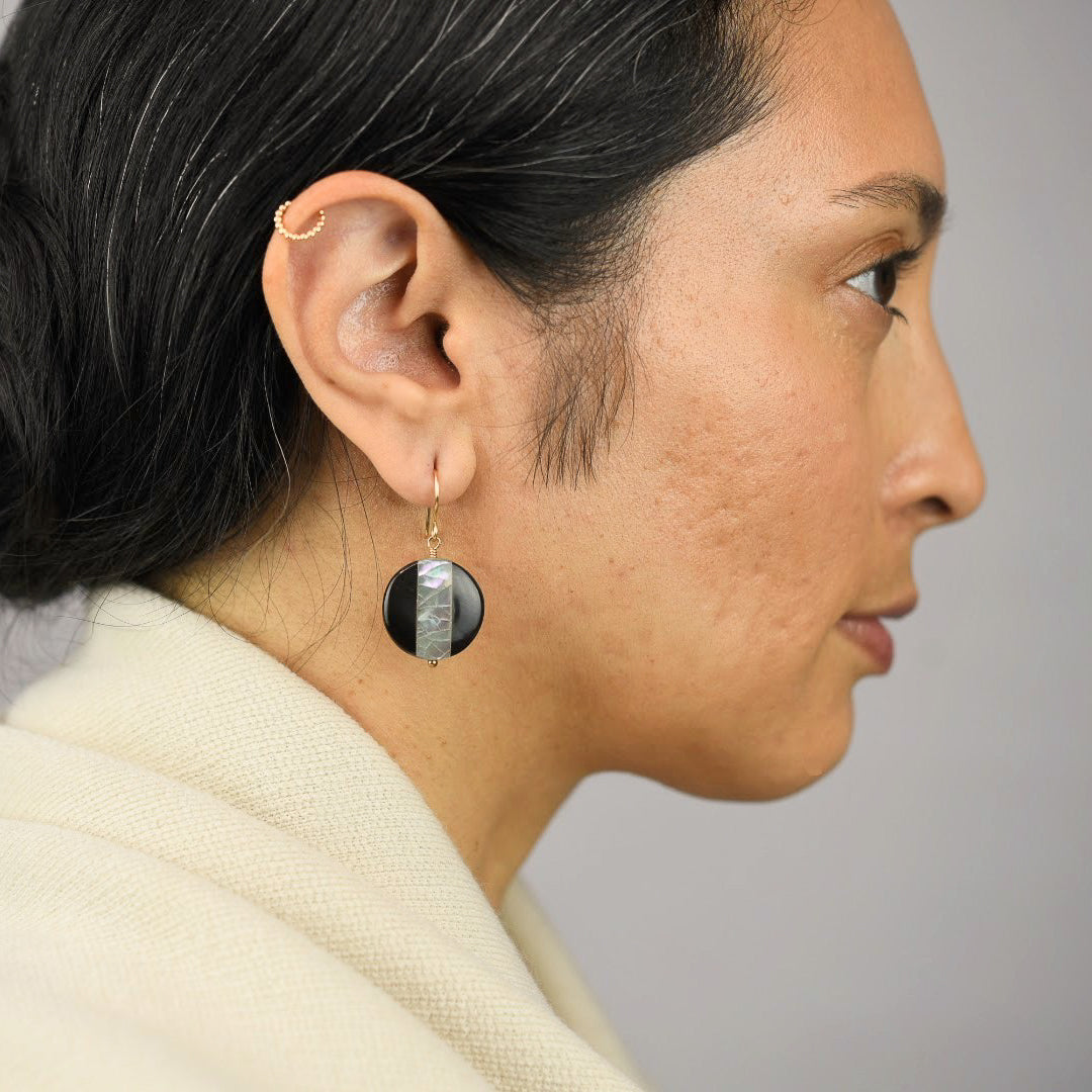 Close up image of a model wearing 14K gold filled Abalone Inlay Earrings from Zurina Ketola