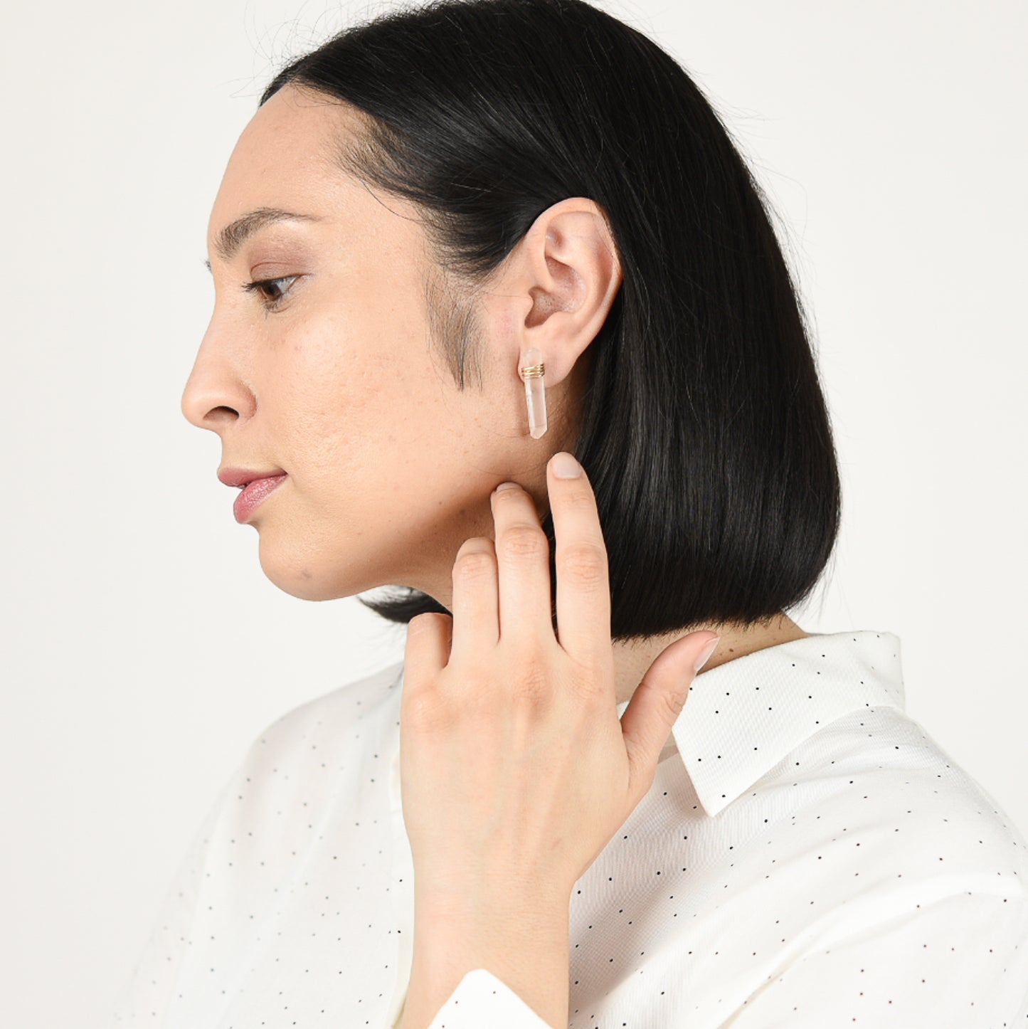 Model wearing rose quartz crystal posts.