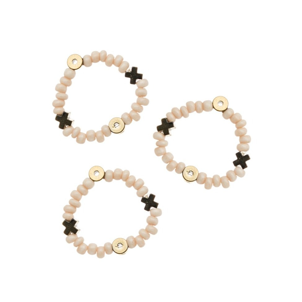 Zurina Ketola sweet beaded stacking rings in pale blush with hematite XOXO details close up on white background