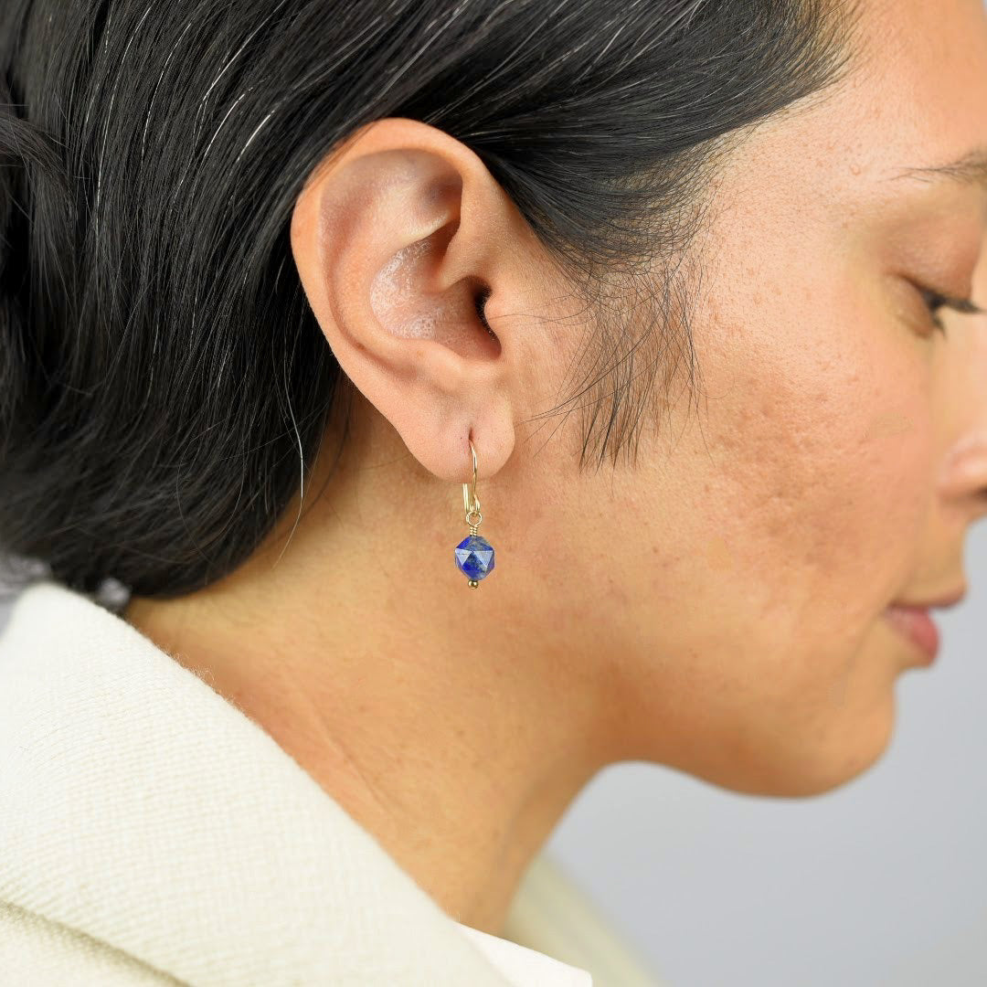  Close up image of a model wearing 14K gold fill Rose Cut Lapis Earrings from Zurina Ketola