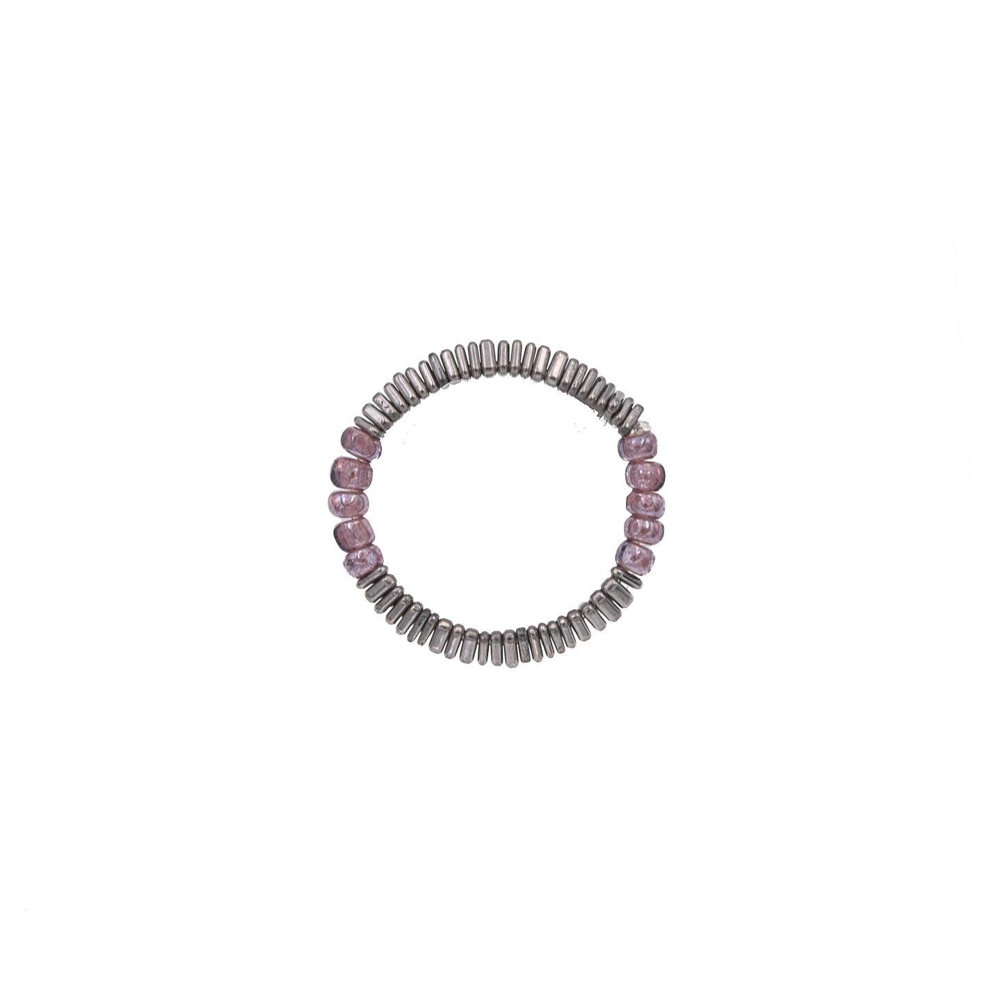 Zurina Ketola Beaded Stretch Ring with Purple Seed Beads and Tiny Triangle Hematite Details on White Background. 