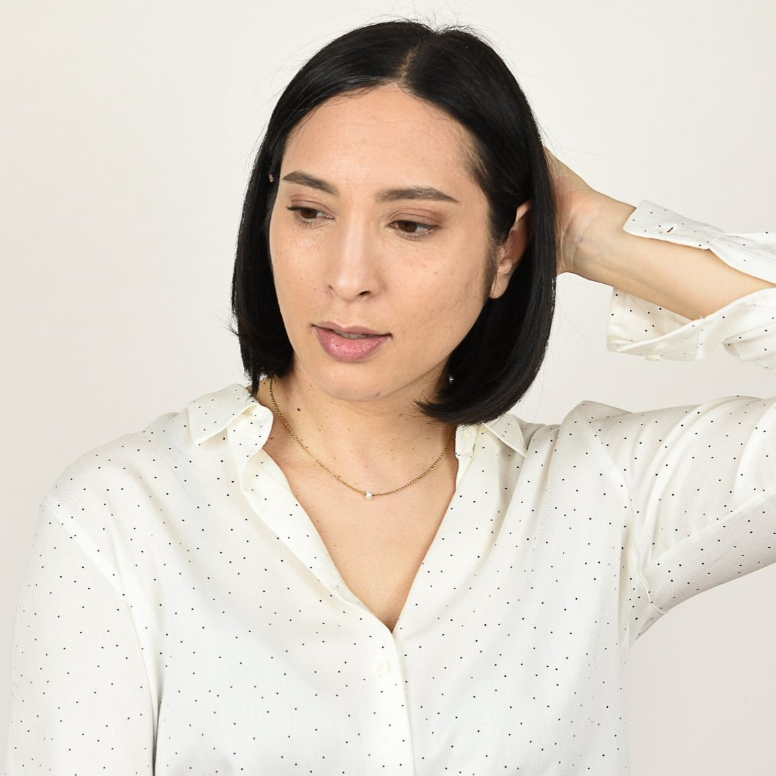 Model wearing pearl necklace