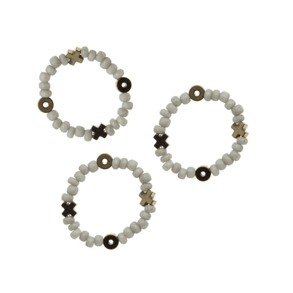 Zurina Ketola Designs sweet beaded stacking rings in pale blue with hematite XOXO details close up on white background